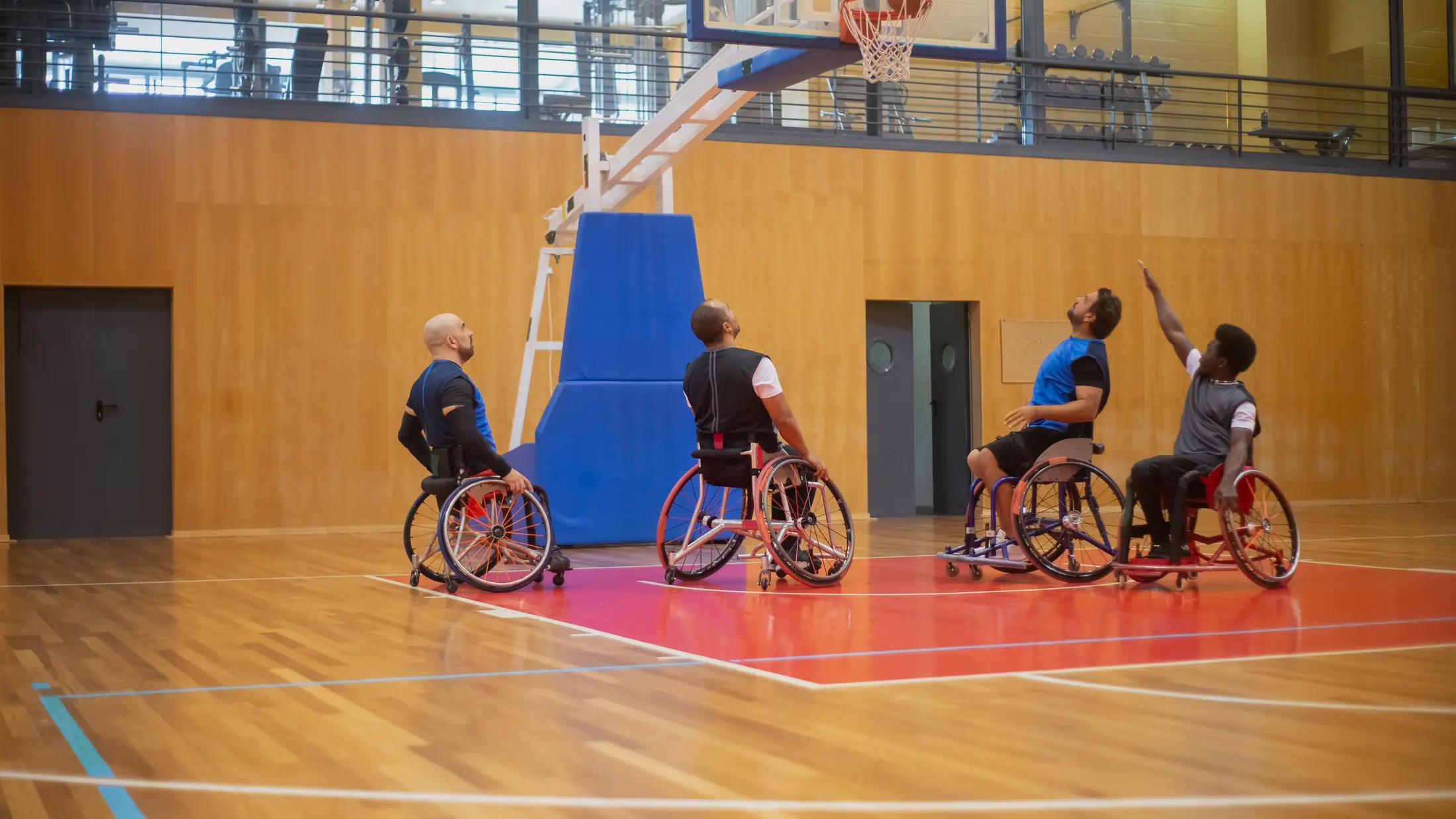 Joueurs de basket en fauteuil pendant un entraînement en gymnase